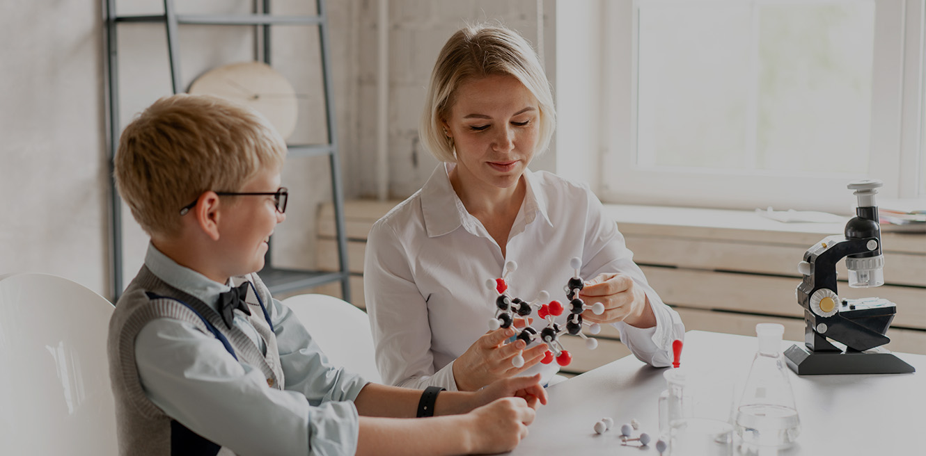 Female science tutor in Arlington studying chemistry with student